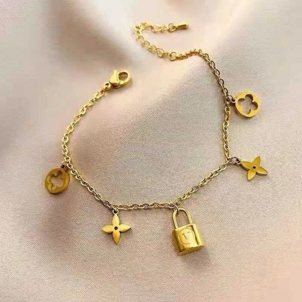 18K Gold Designer Charm Bracelet with Lock and Flower Accents - Picture 2 of 8